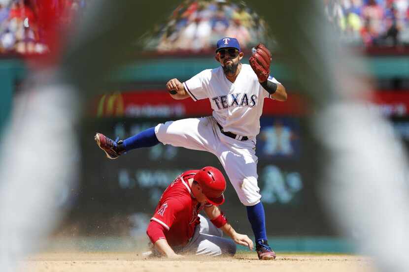 Texas Rangers second baseman Rougned Odor (12) watches as he completes a double play as Los...