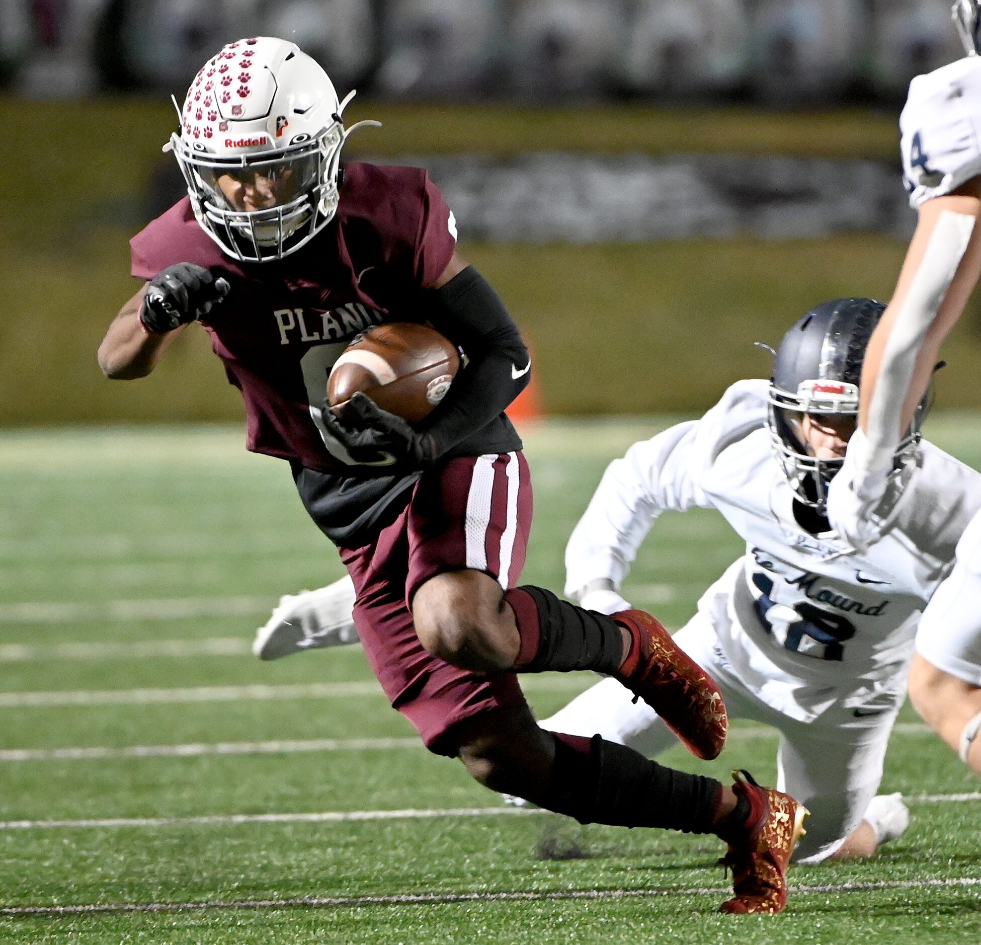 Plano's Kavion Grady (6) runs upfield past Flower Mound's Cooper Davis (18) in the first...