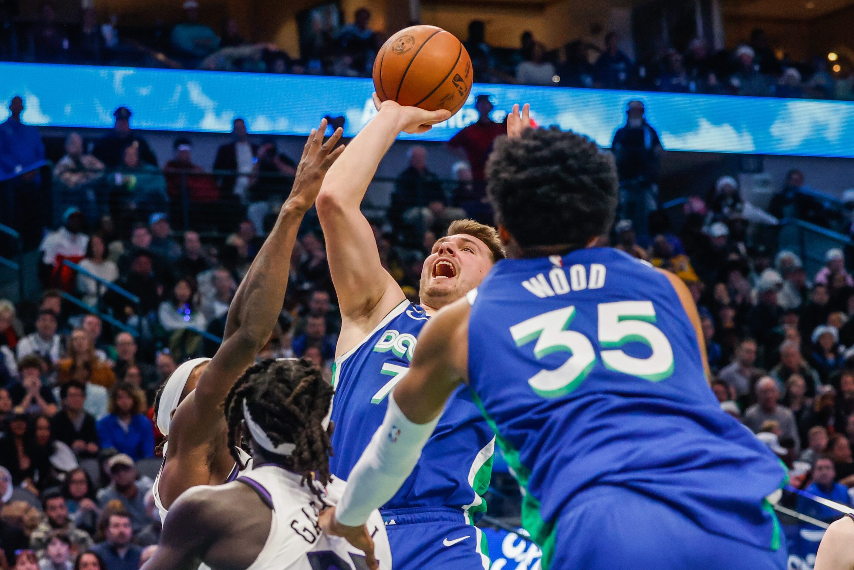 Dallas Mavericks guard Luka Doncic (77) goes for a shot during the third quarter at the...