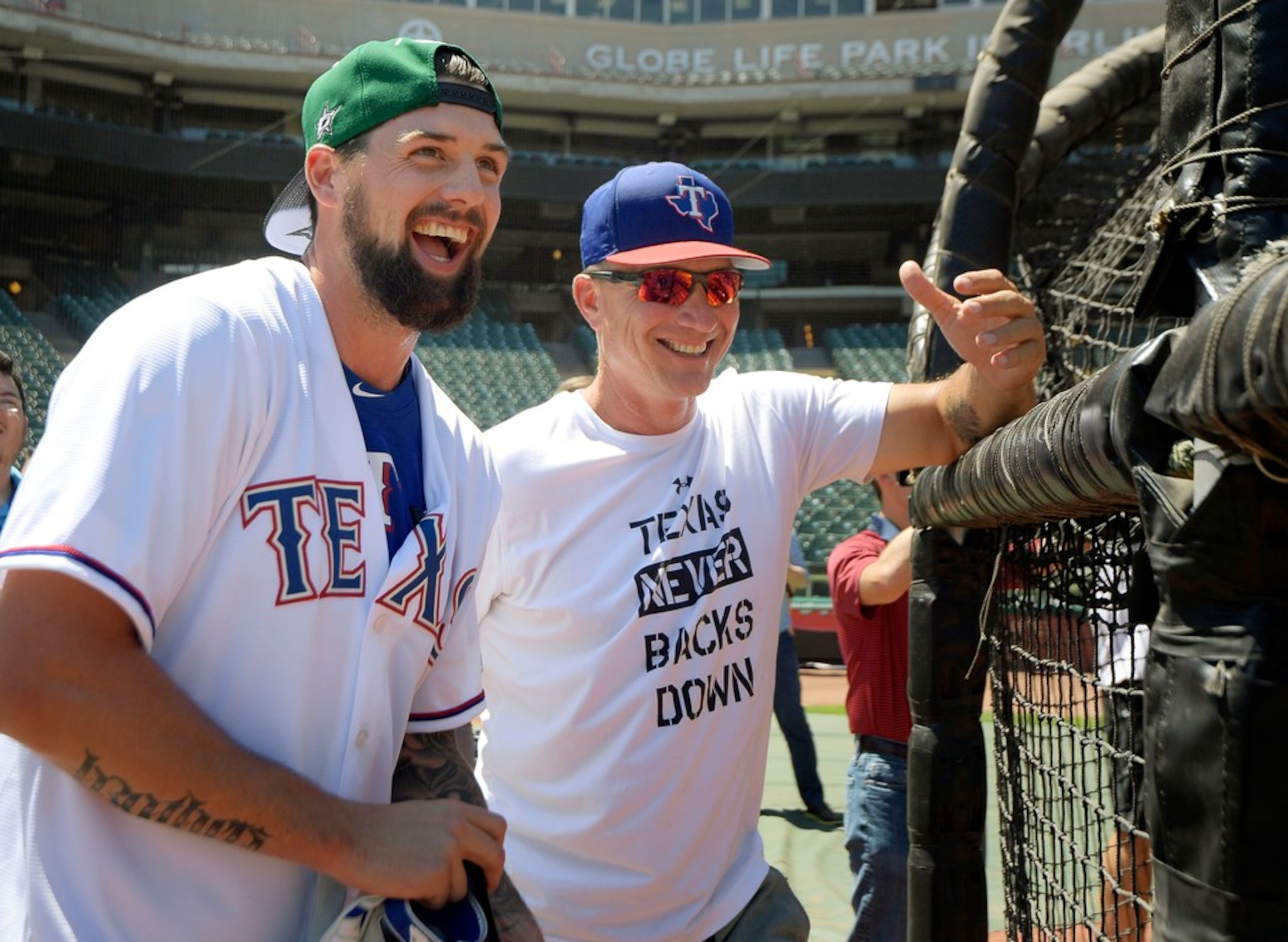 Dallas Stars team captain and left wing Jamie Benn, left, talks to Texas Rangers manager...