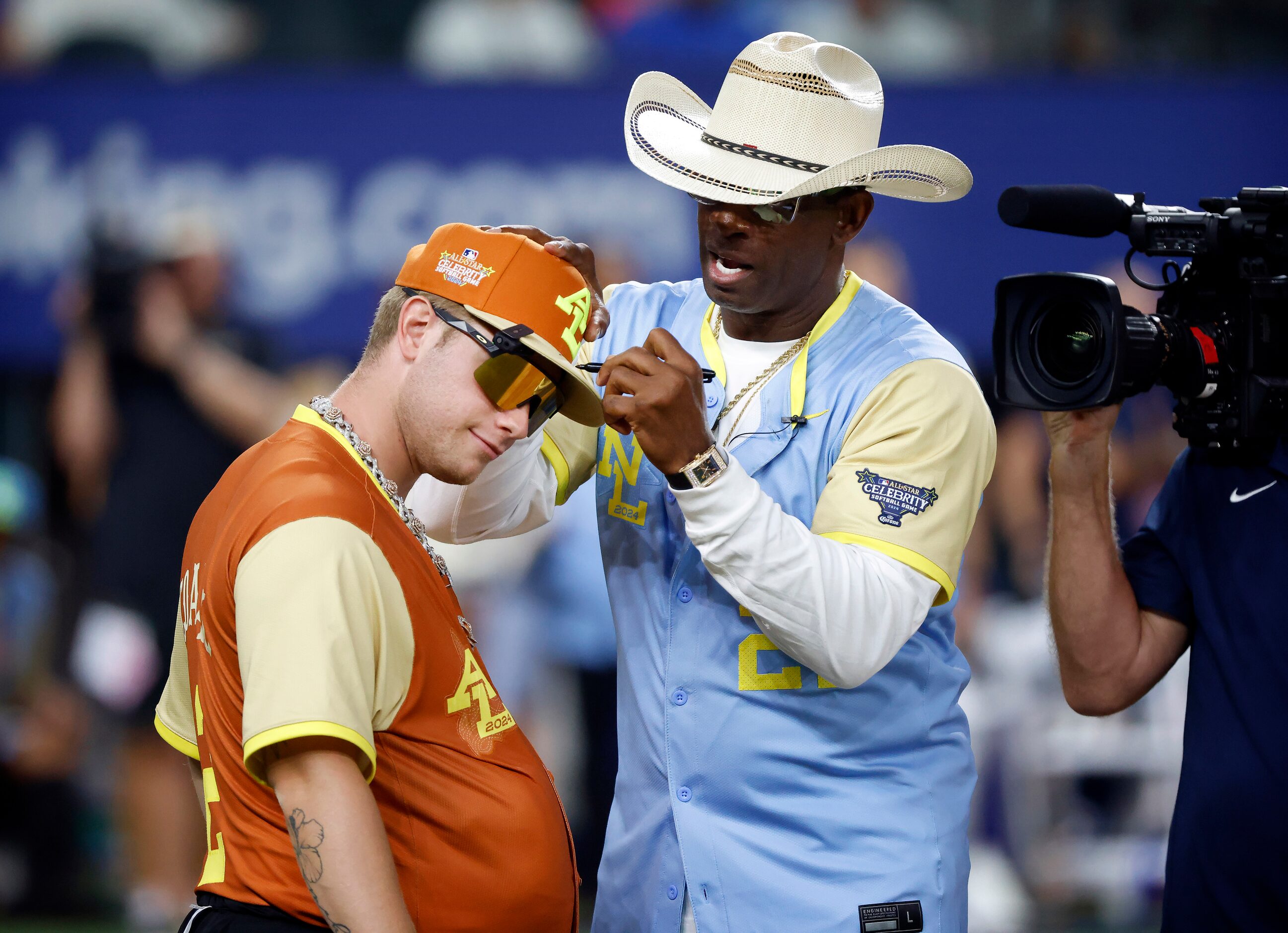 Colorado Buffaloes head football coach Deion Sanders signs an autograph for influencer Nicky...