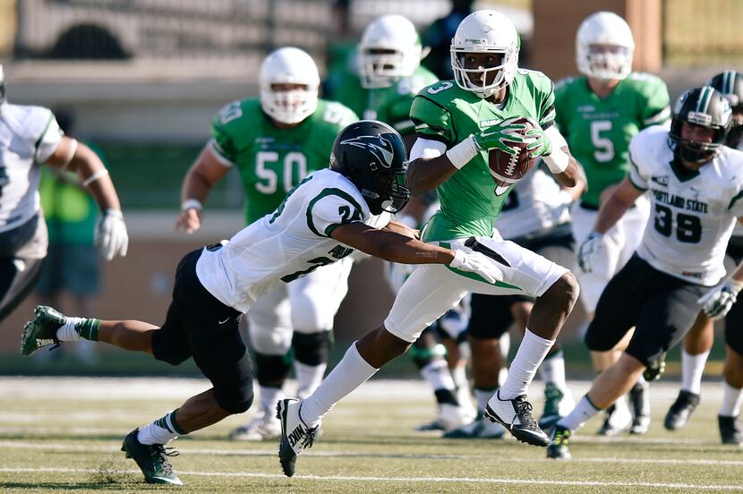 North Texas freshman wide receiver Tee Goree (3) tries to speed away from Portland State...