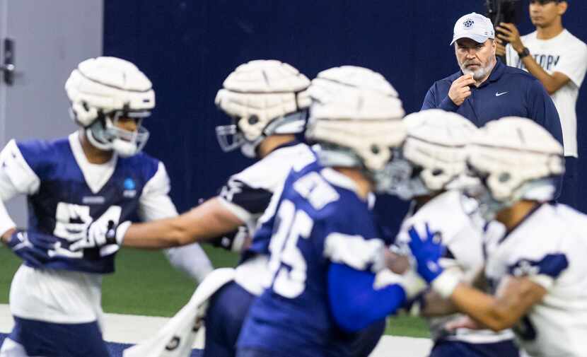 Dallas Cowboys head coach Mike McCarthy, top right, looks on during a minicamp practice at...