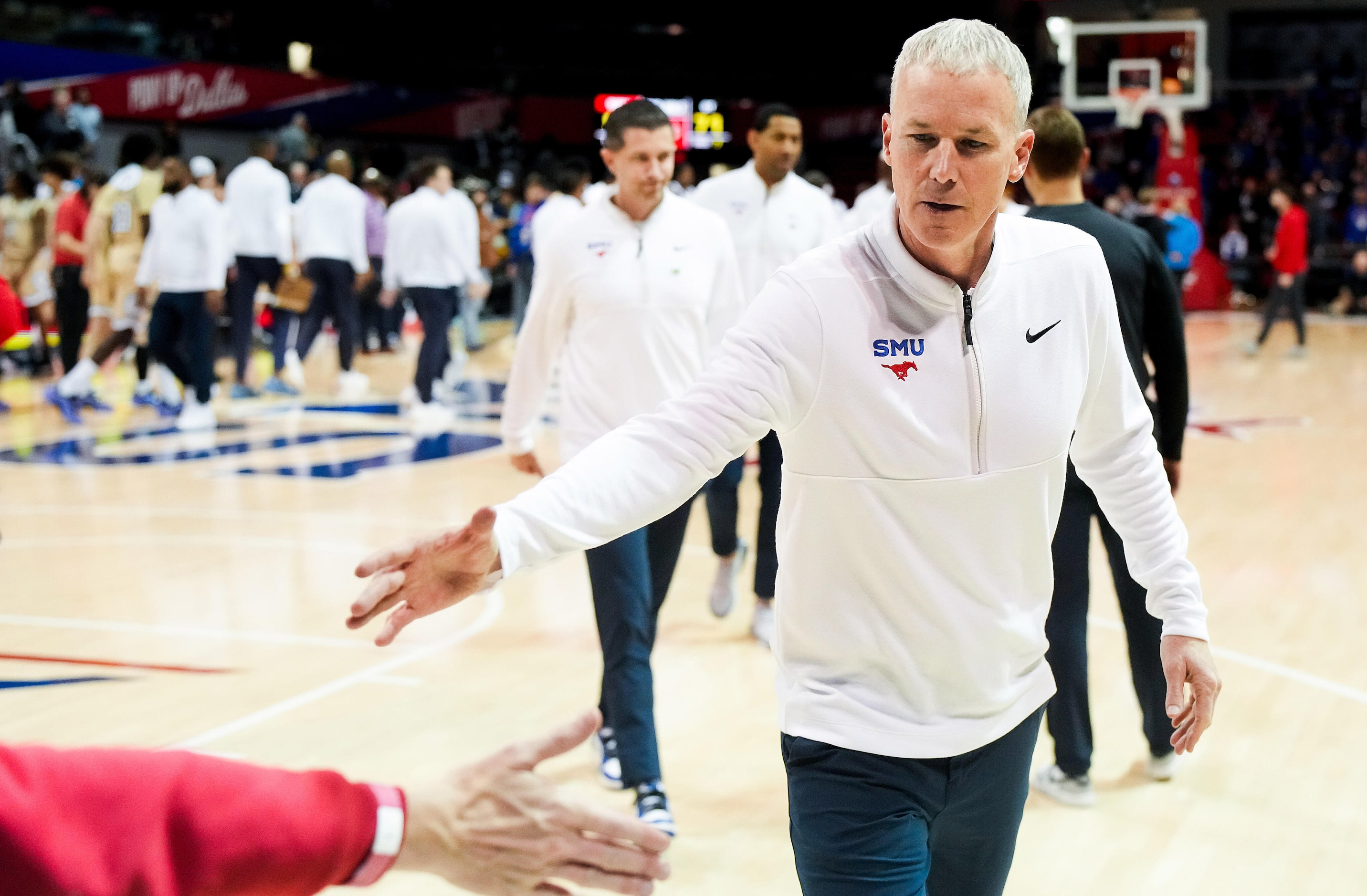 SMU head coach Andy Enfield shakes hands with fans after a victory over Georgia Tech in an...