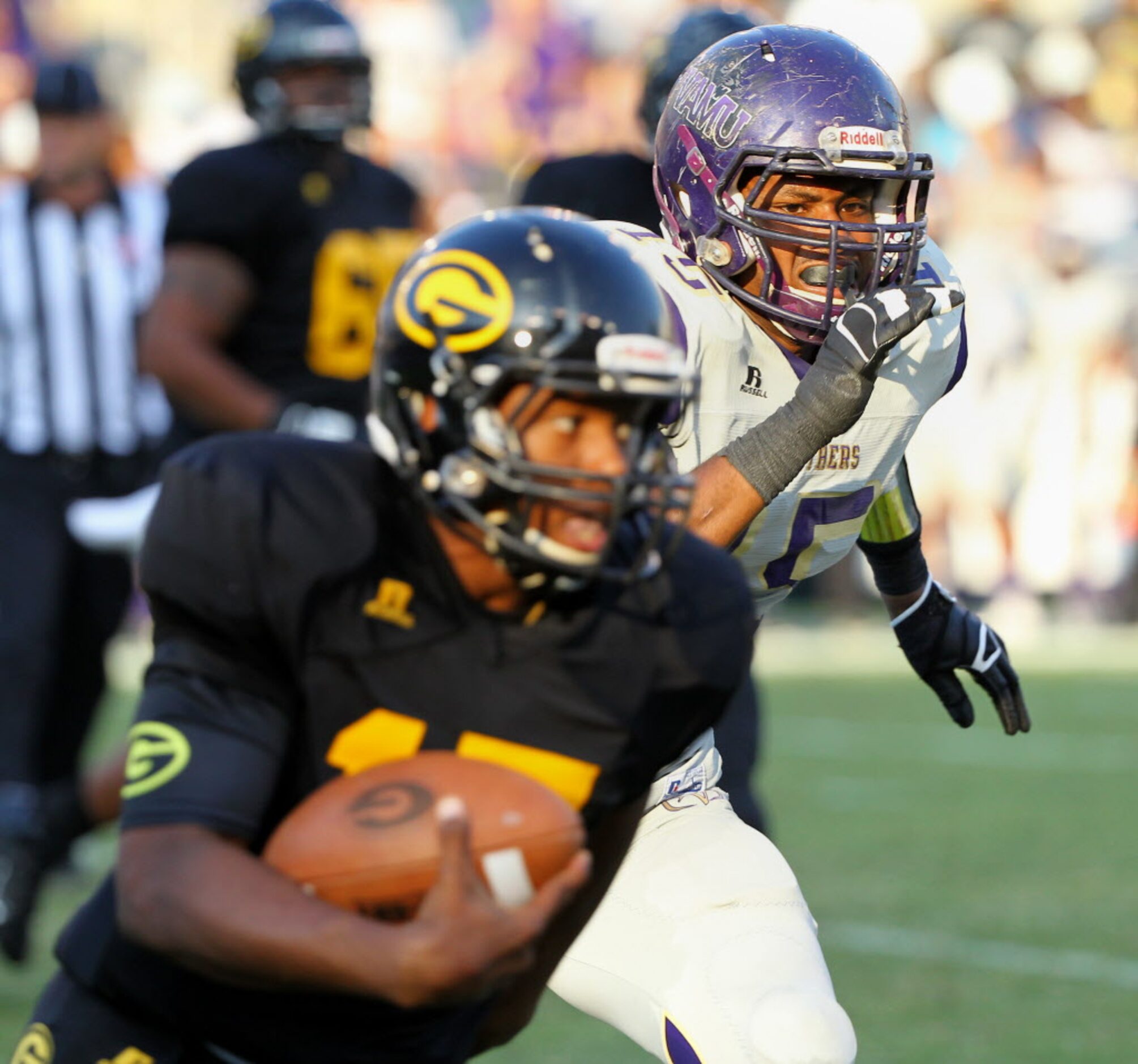 Grambling State quarterback Johnathan Williams (17) runs from Prairie View A&M linebacker...