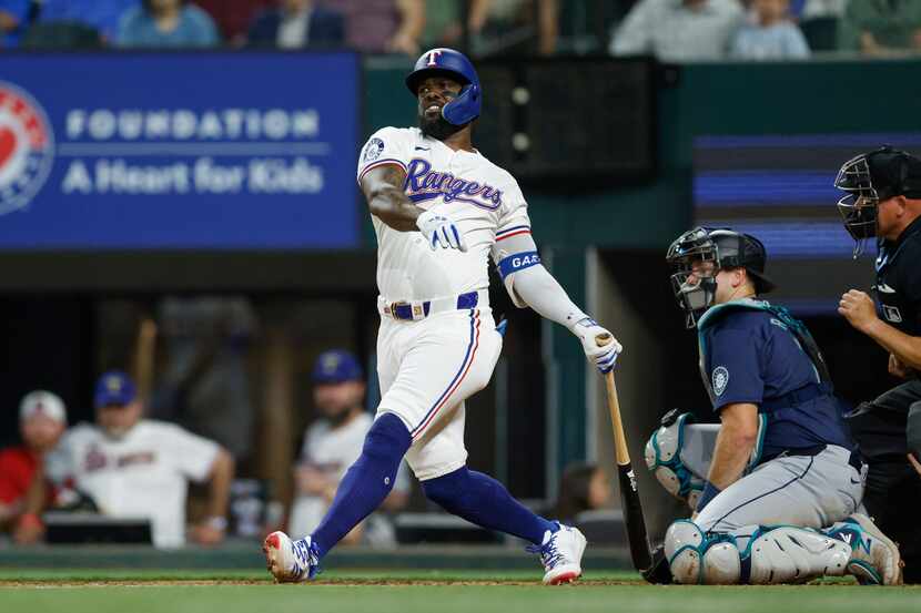 Texas Rangers right fielder Adolis Garcia (53) swings at a pitch during the sixth inning...