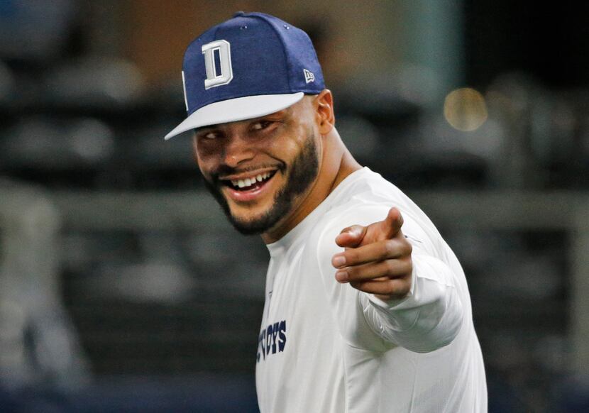Dallas Cowboys quarterback Dak Prescott (4) gestures to a fan during early warmups before...