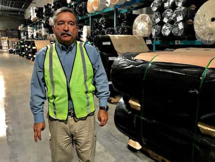 Alexander Sierra, plant manager at ACME mills, walks through his distribution warehouse June...