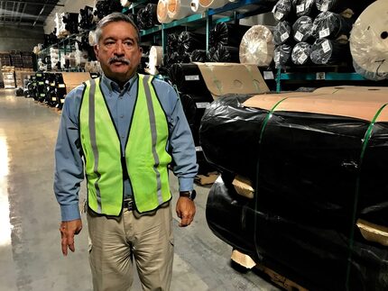 Alexander Sierra, plant manager at ACME mills, walks through his distribution warehouse June...