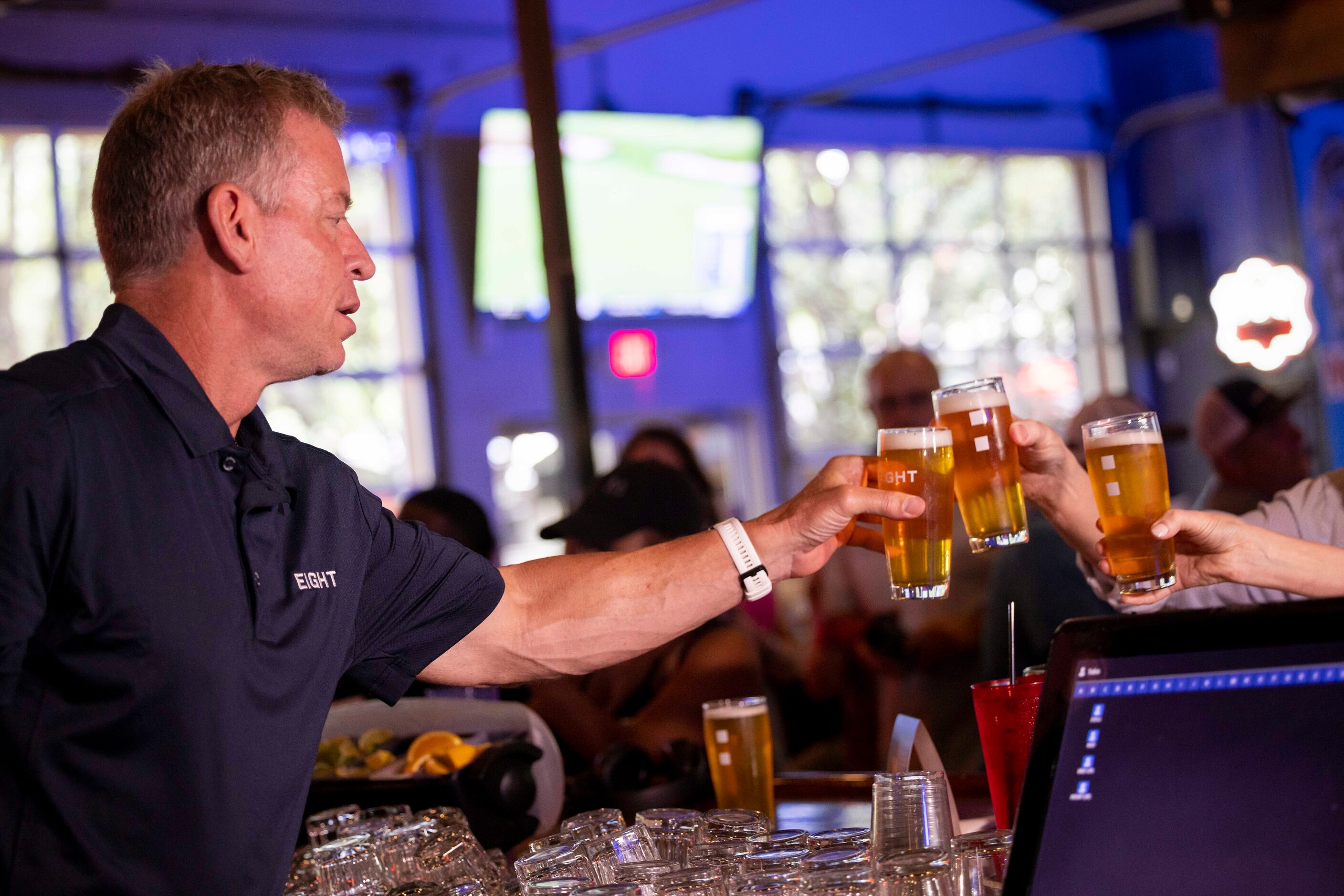 Former Cowboys quarterback Troy Aikman cheers with his beer EIGHT at Katy Trail Ice House...