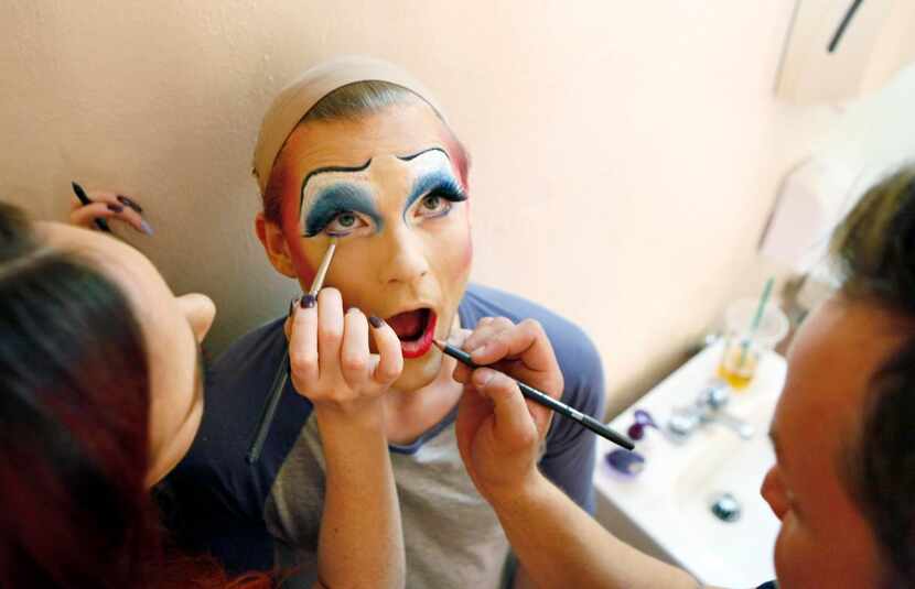 
Makeup artist Laura Neeley (left) and hair and makeup stylist Michael Moore place the...