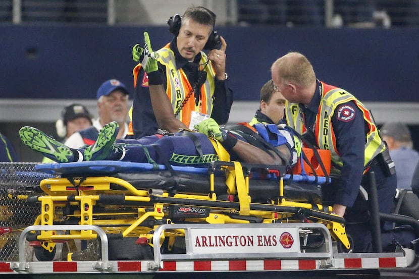 Seattle Seahawks wide receiver Ricardo Lockette (83) is carted off the field after being...