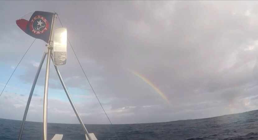 A rainbow appeared in a gray sky over the team as it rowed across the ocean.