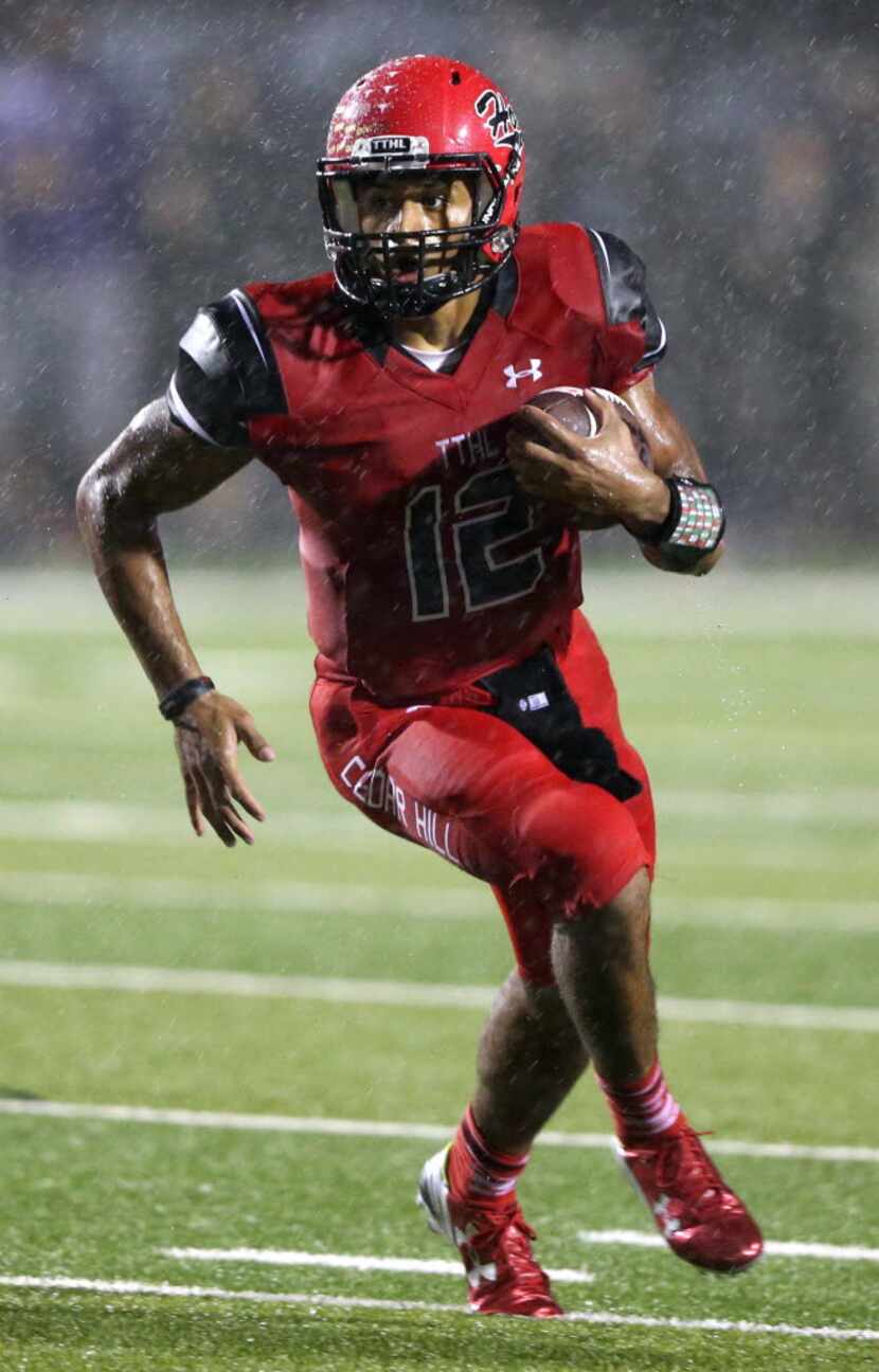 Cedar Hill's Avery Davis (12) on a run attempt in a game against DeSoto during the first...