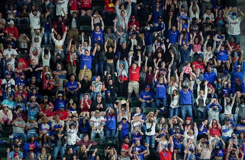 Texas Rangers fans do the wave during the eighth inning against the Baltimore Orioles at...