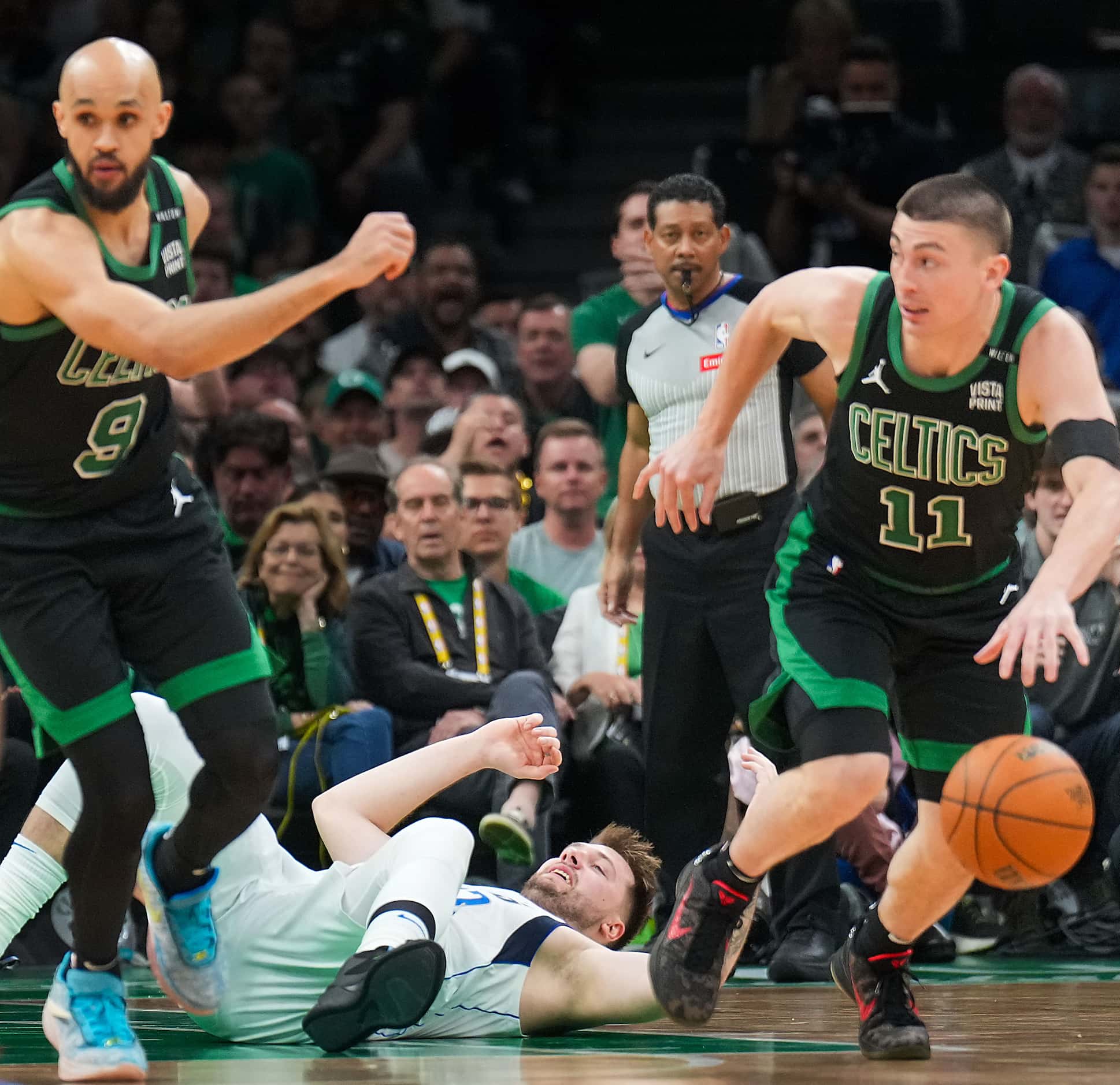 Dallas Mavericks guard Luka Doncic hits the floor as Boston Celtics guard Payton Pritchard...