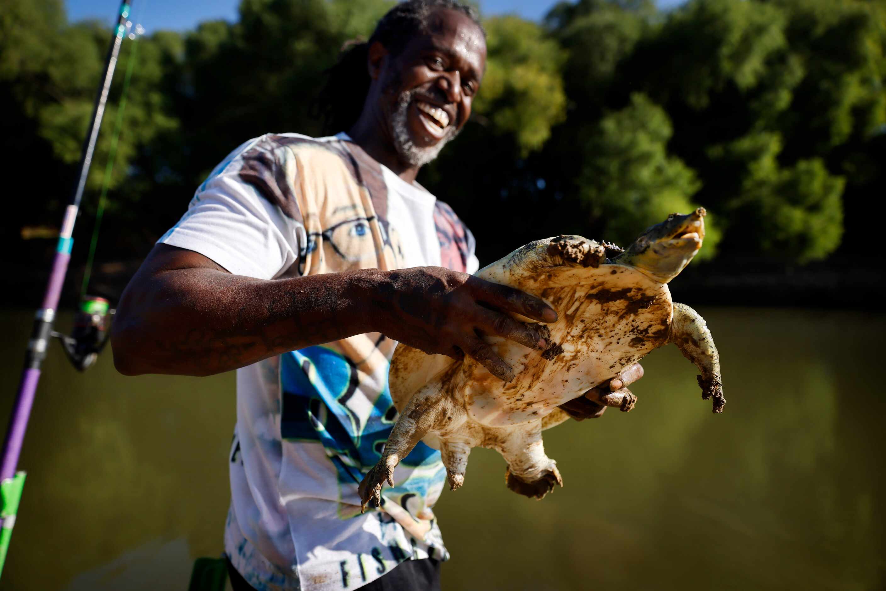 Odell Allen laughs after he reeled in a softshell turtle instead of an alligator gar on the...