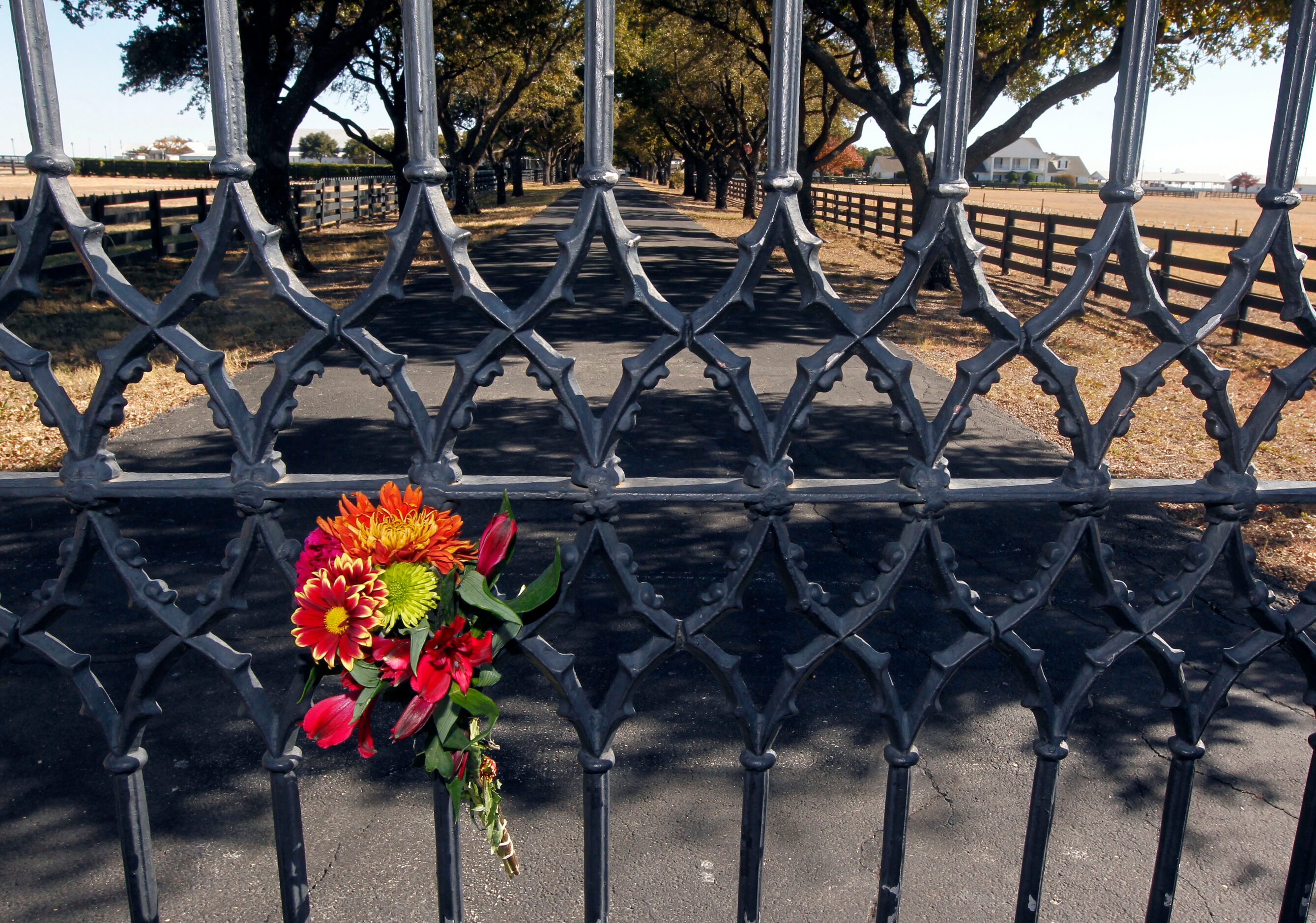 A lone bouquet of flowers is positioned on the entrance to Southfork Ranch in Parker, Texas...