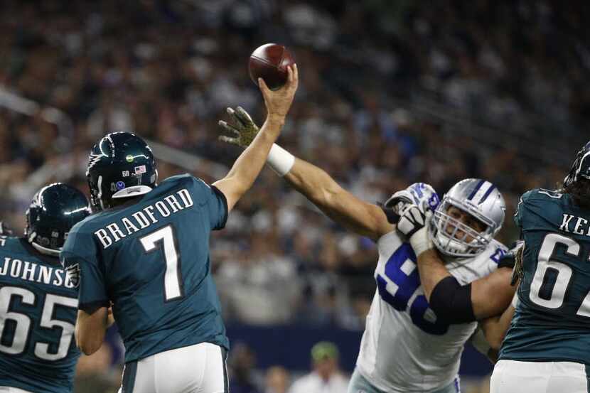 Dallas Cowboys defensive tackle Tyrone Crawford (98) hits Philadelphia Eagles quarterback...