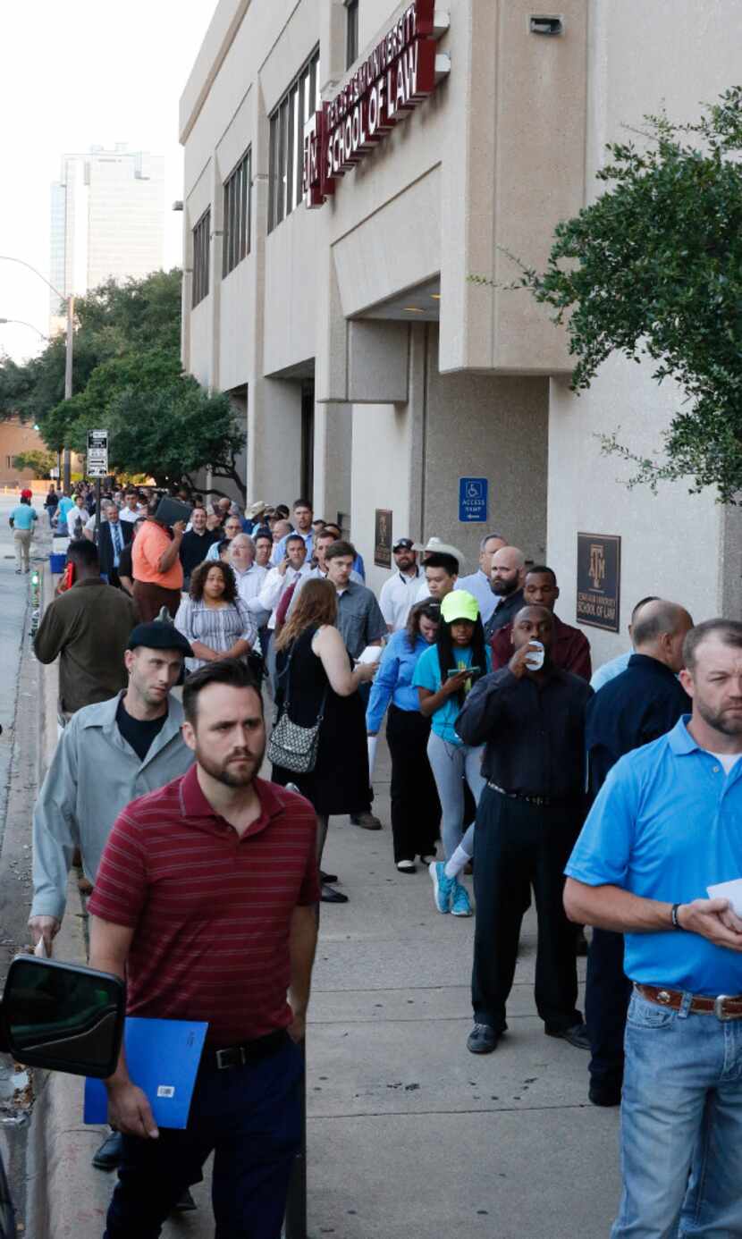 Hundreds of job candidates waited in line in August to apply for manufacturing positions for...