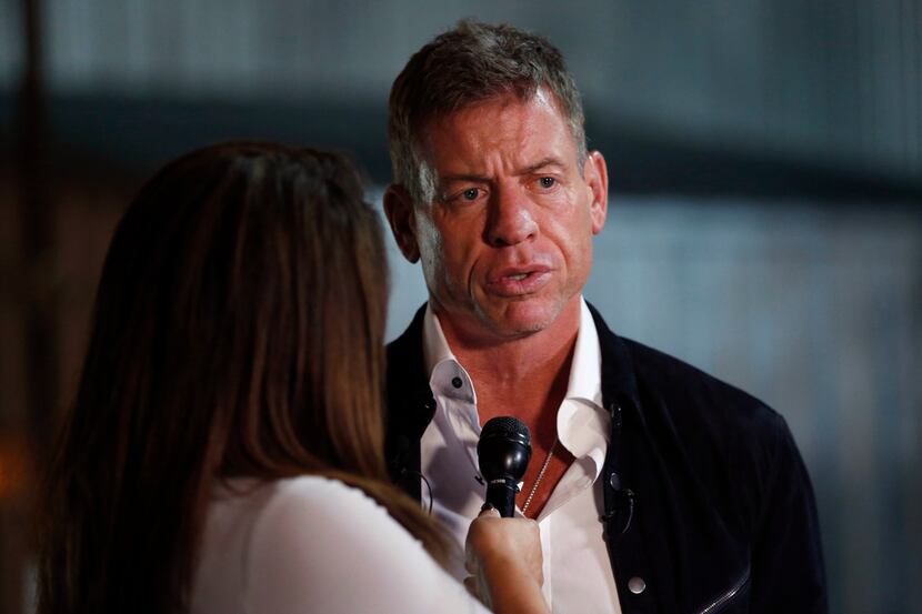 Former Dallas Cowboys quarterback Troy Aikman speaks to WFAA reporter Rebecca Lopez during...