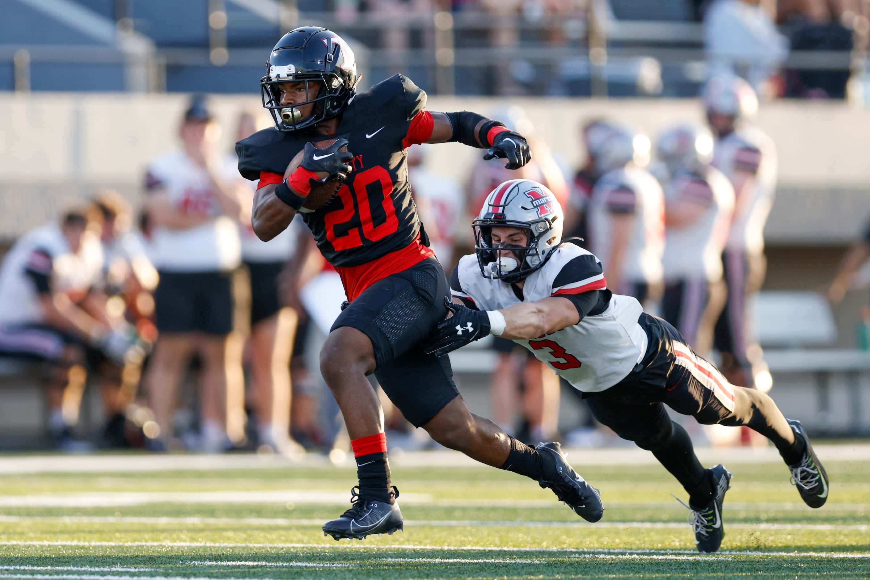 Euless Trinity running back Josh Bell (20) runs through a tackle from Flower Mound Marcus...