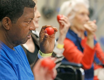 Oscar Hinchen works to stay in rhythm during a music therapy clinic.