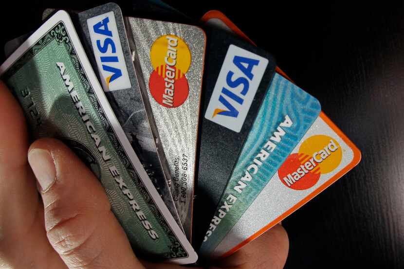 FILE - In this March 5, 2012, file photo, consumer credit cards are posed in North Andover,...