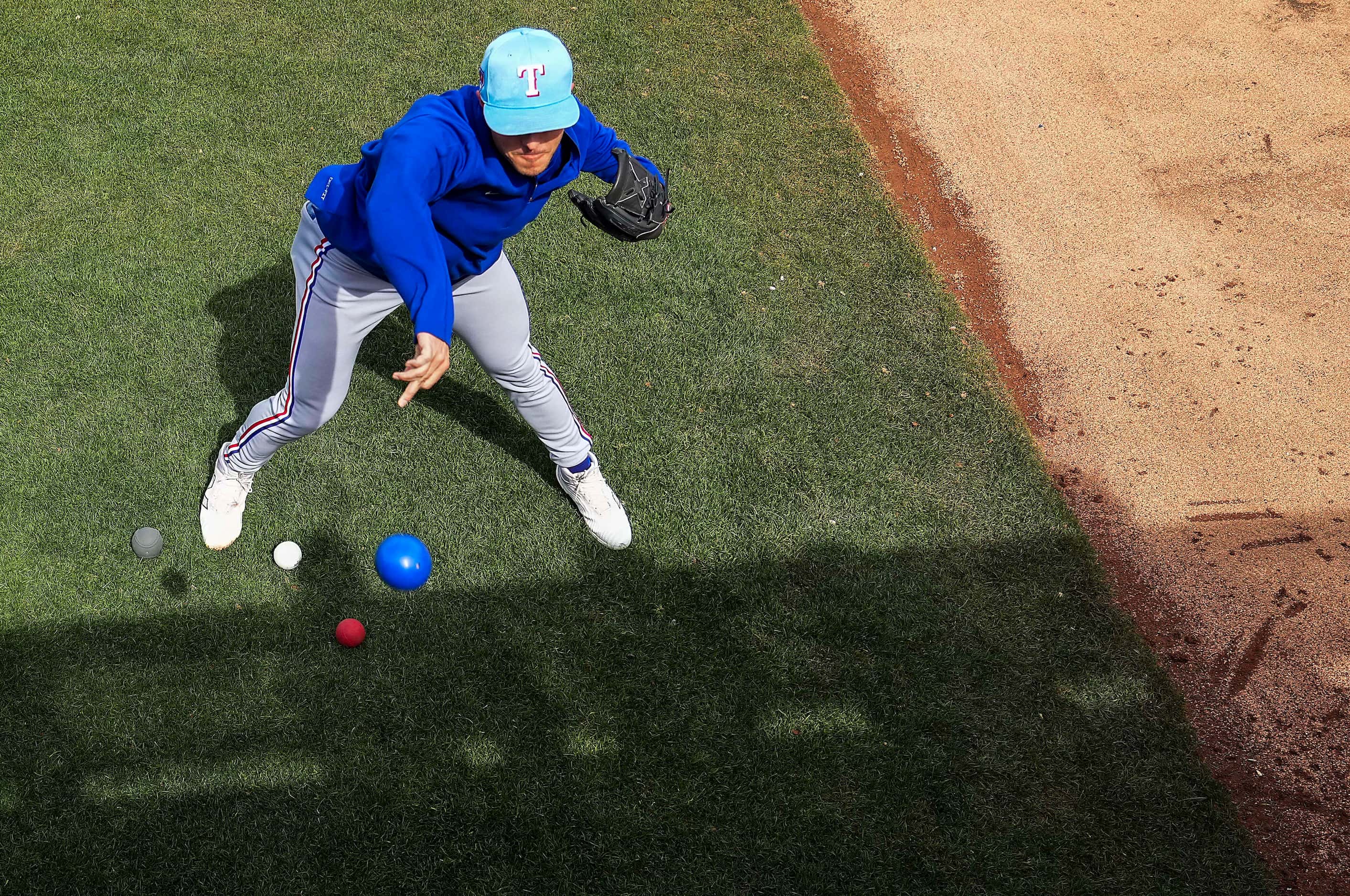 Texas Rangers pitcher Jack Leiter tosses a heavy ball in the bullpen before a spring...