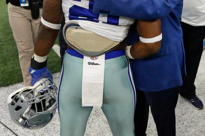 Dallas Cowboys running back Ezekiel Elliott (21) gets a pregame hug from Cowboys owner Jerry...