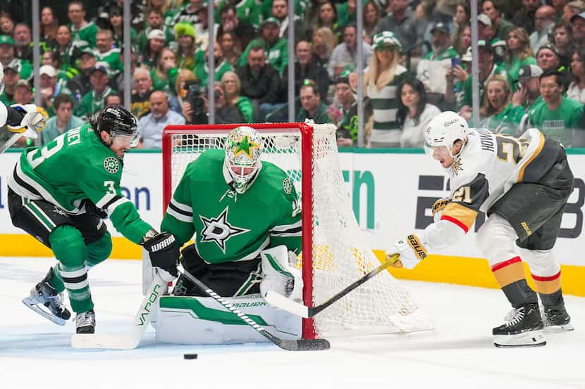 Vegas Golden Knights center Brett Howden (21) tries to wrap the puck around the net as...