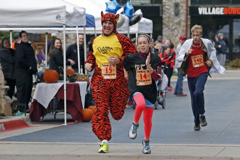 Jim Carroll of Allen dressed as Tigger and raced his daughter Ellie to the finish line in a...