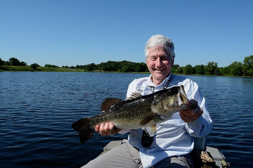 Ron Gard demonstrates the correct way to hold any bass you intend to release. Gard s 38-acre...