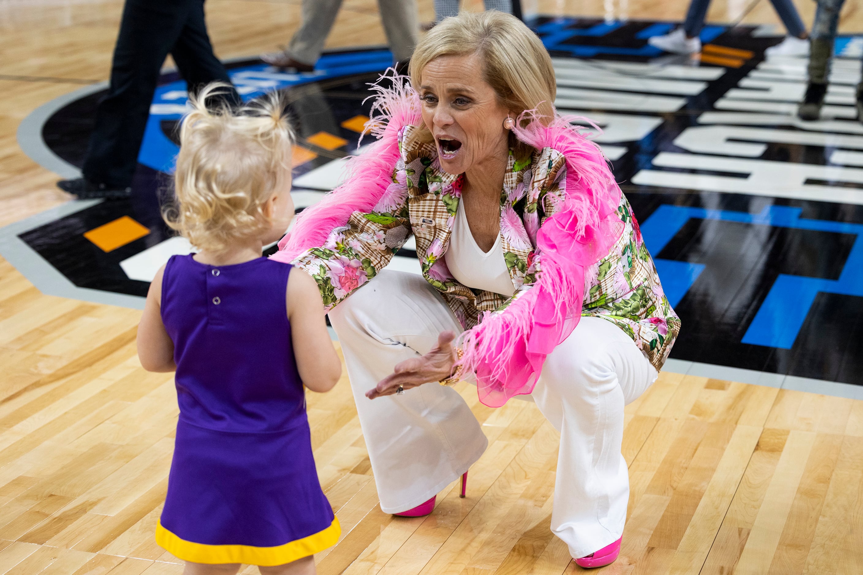 LSU coach Kim Mulkey greets a young person after LSU defeated Utah in a Sweet 16 college...