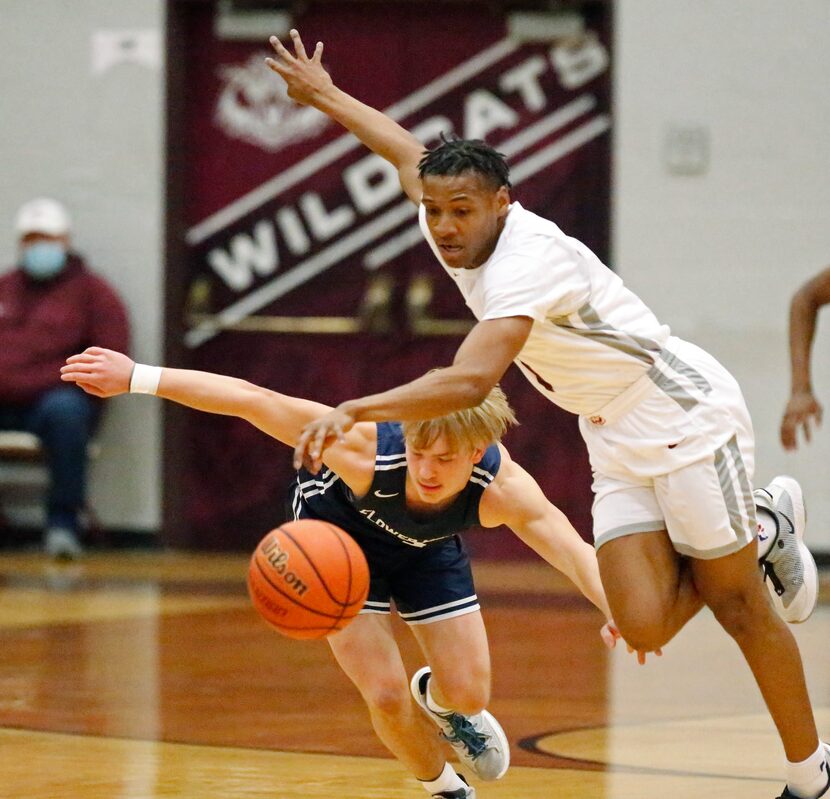 Plano Senior High School forward Makhi Dorsey (1) steals the ball from Flower Mound High...