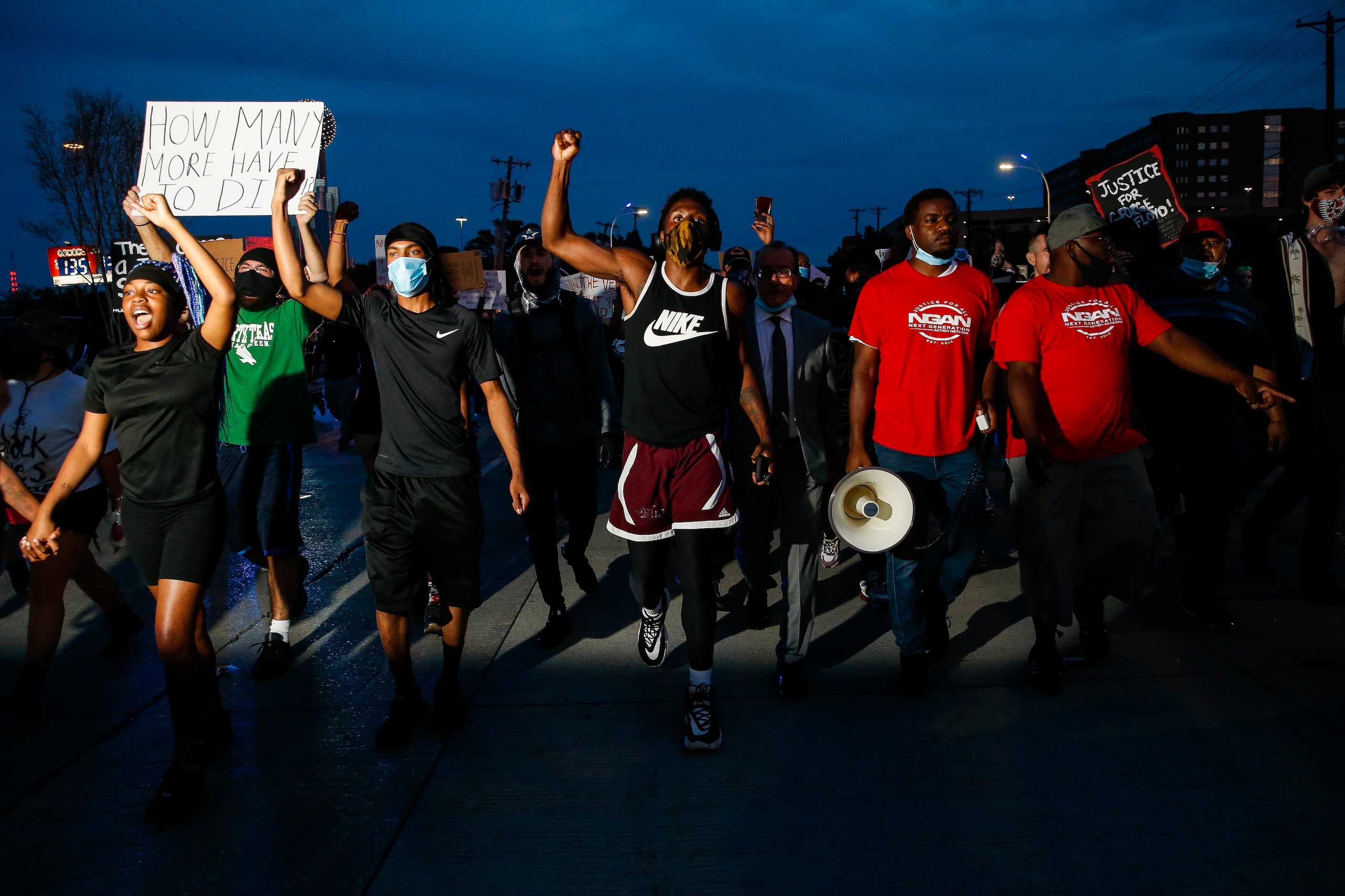 Protesters march to the Margaret Hunt Hill Bridge as they demonstrate against police...