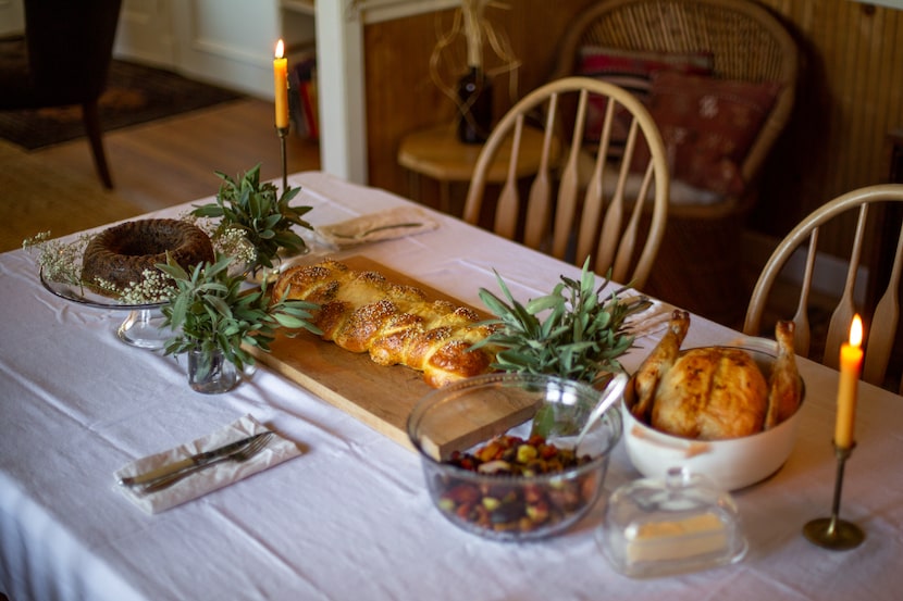 A spread of chocolate beet cake, challah bread, oven-roasted vegetables and oven-roasted...