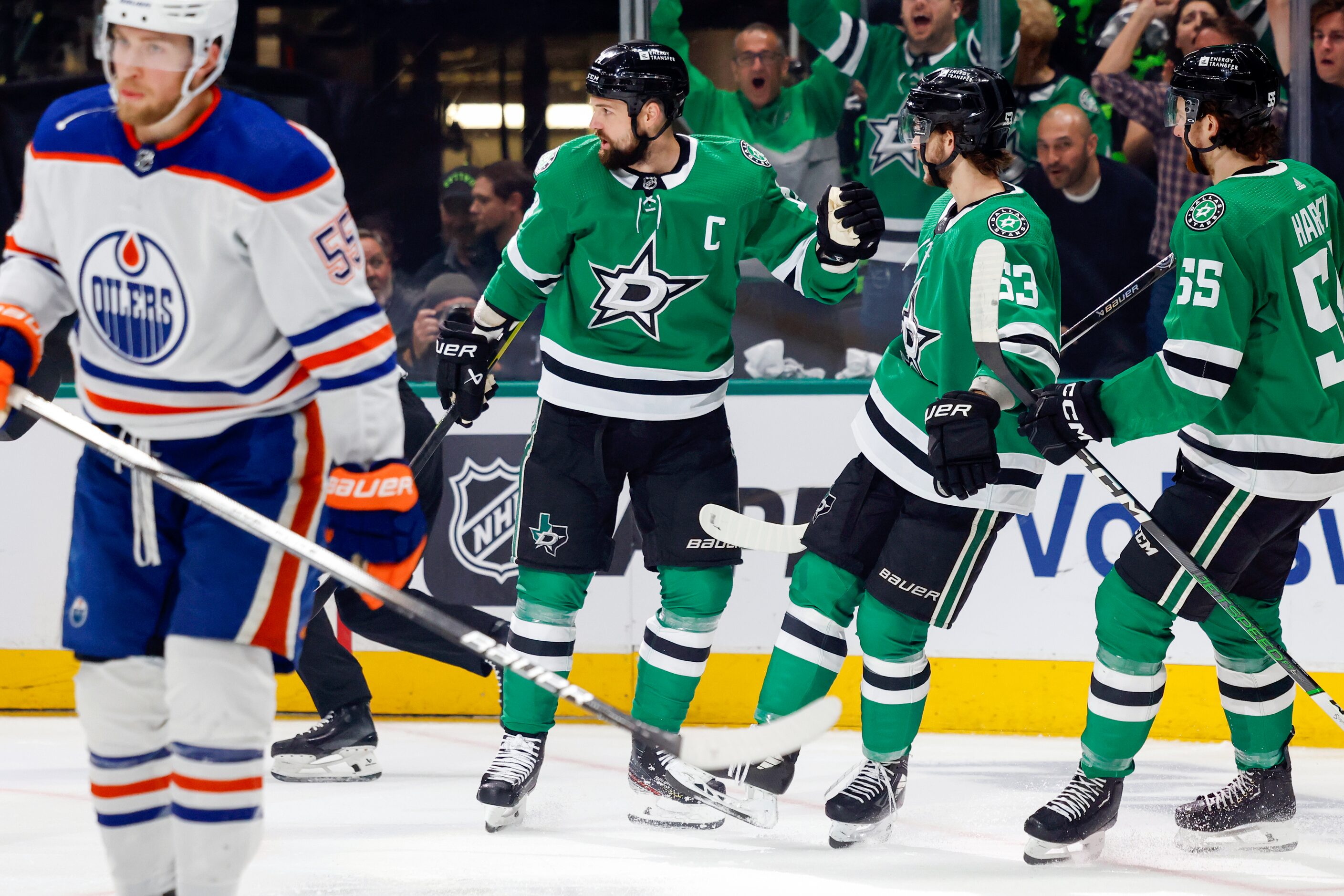 Dallas Stars left wing Jamie Benn (14) celebrates after scoring a goal with center Wyatt...