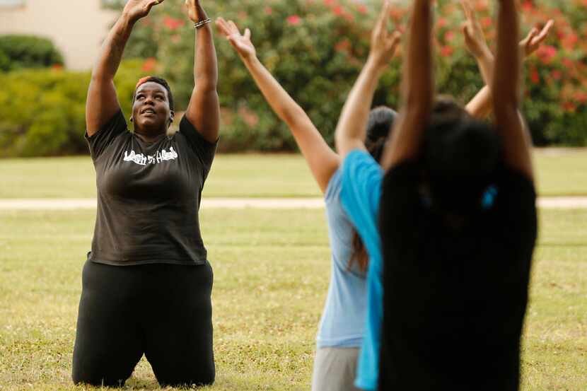 Instructor Ebony Smith leads a Yoga N Da Hood class at Fair Park in Dallas on Wednesday, May...