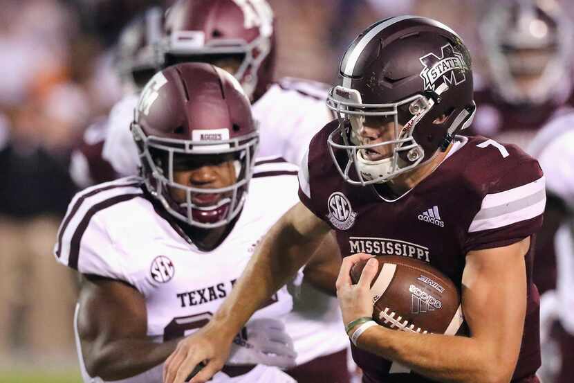 Mississippi State quarterback Nick Fitzgerald (7) rushes for additional yards as Texas A&M...