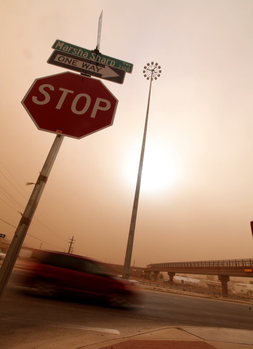 Cars navigate along the Marsha Sharp Freeway during a dust storm in Lubbock, Texas,...