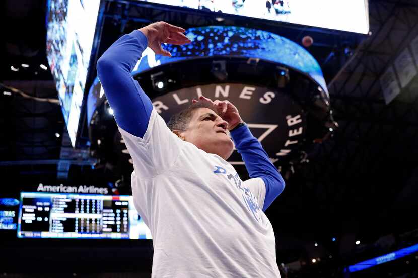 Dallas Mavericks owner Mark Cuban tries to get the crowd fired up during the first half in...