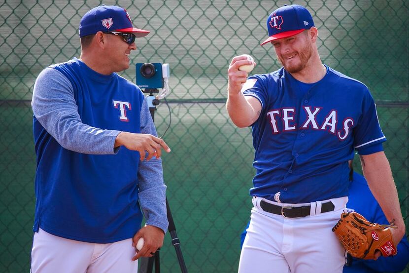 Texas Rangers pitcher Shelby Miller works with  pitching coach Julio Rangel in the bullpen...