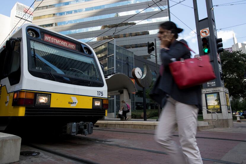 A passenger rushes to board the Red Line DART train at St. Paul Street DART station on Sept....
