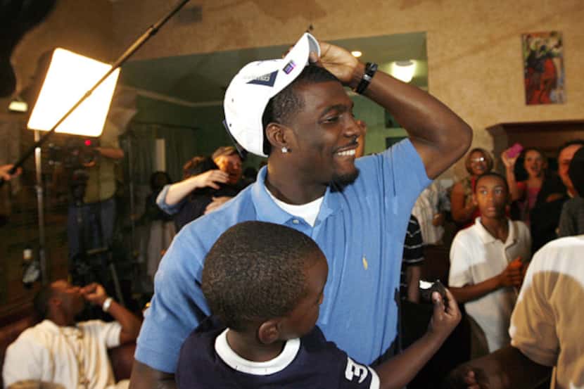 Dez Bryant dons a Cowboys cap after being selected as the 24th overall pick by Dallas in the...