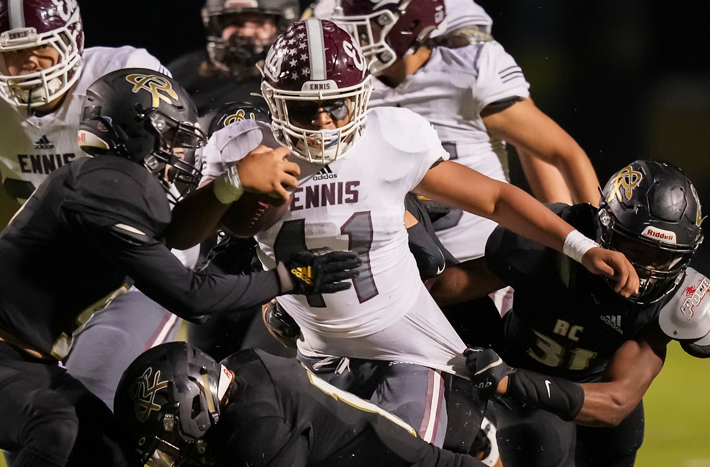 Ennis running back Julio Dominguez (41) is pulled down by Royse City linebacker Christian...
