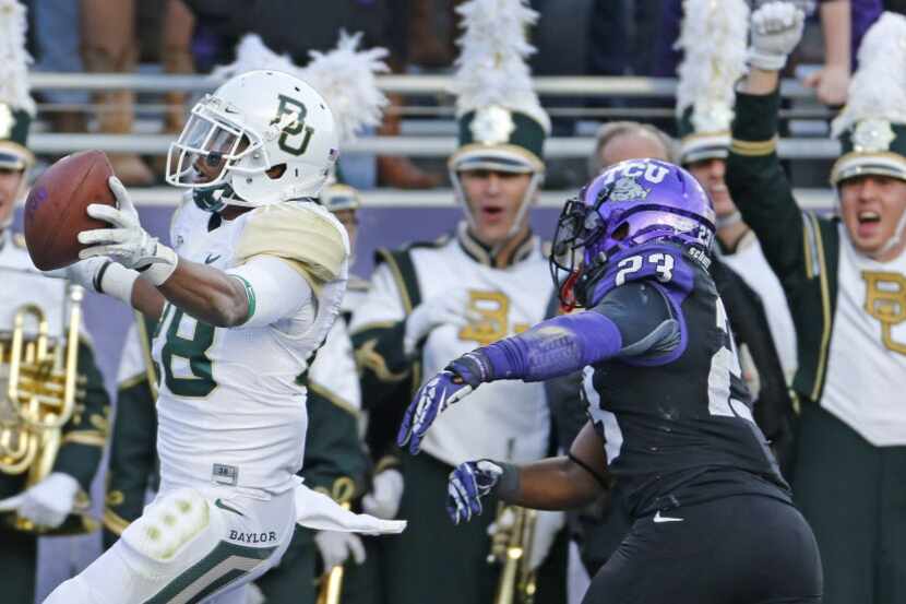 Baylor safety Orion Stewart (28) returns an interception 82 yards for a touchdown near the...