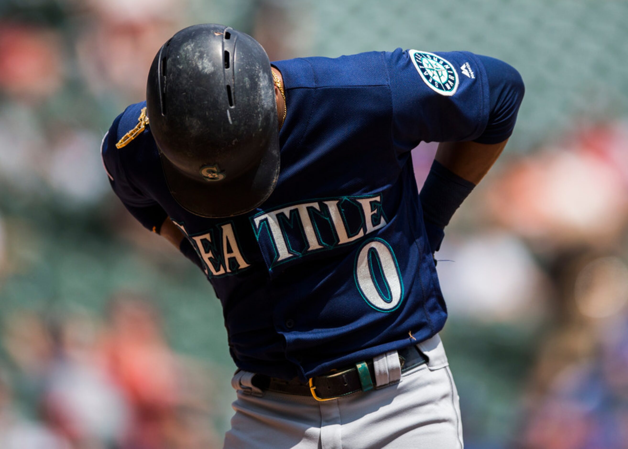 Seattle Mariners right fielder Mallex Smith (0) reacts to getting hit by a pitch from Texas...