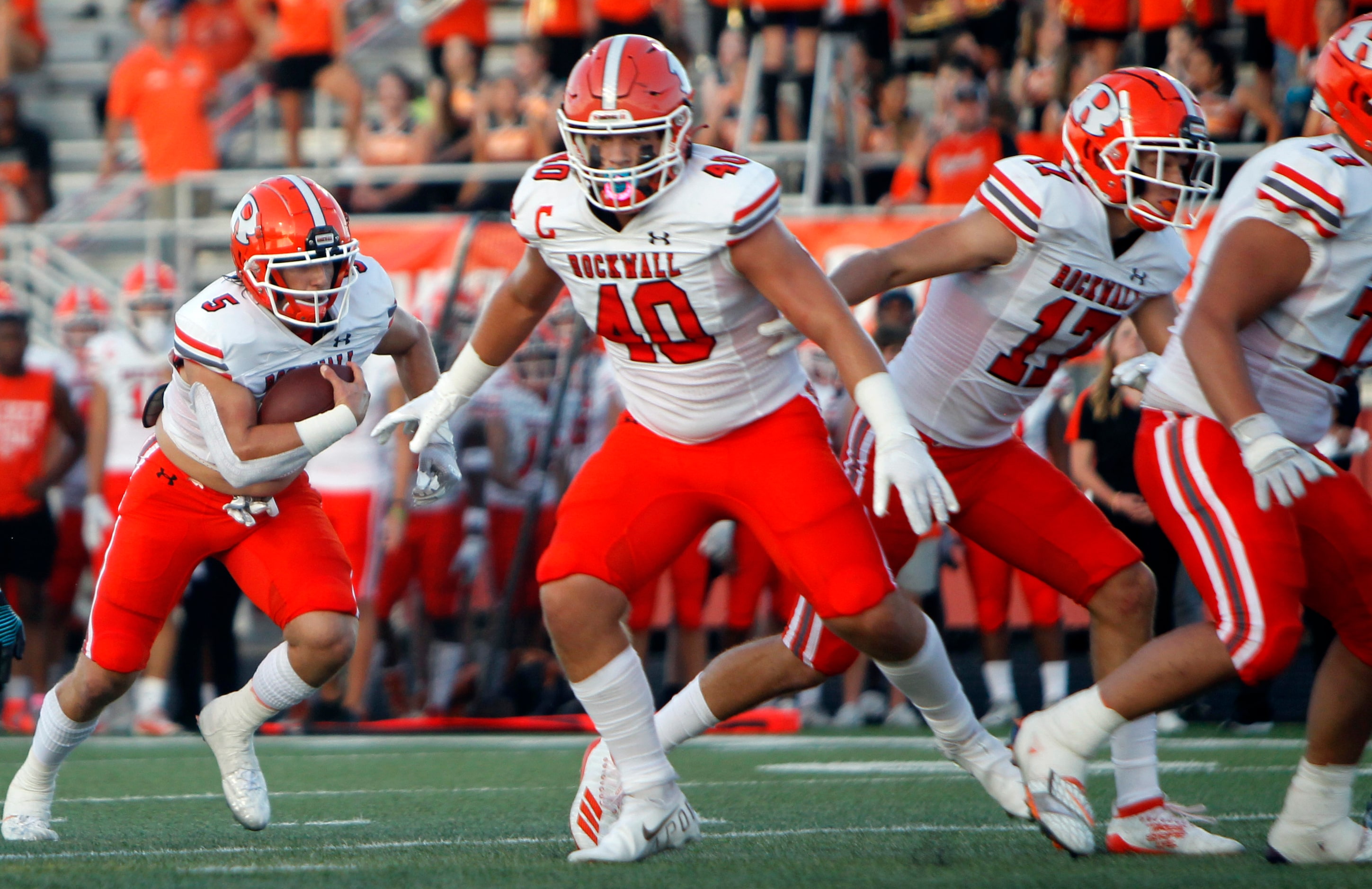 Rockwall quarterback Lake Bennett (5) follows his blockers into the end zone for a rushing...