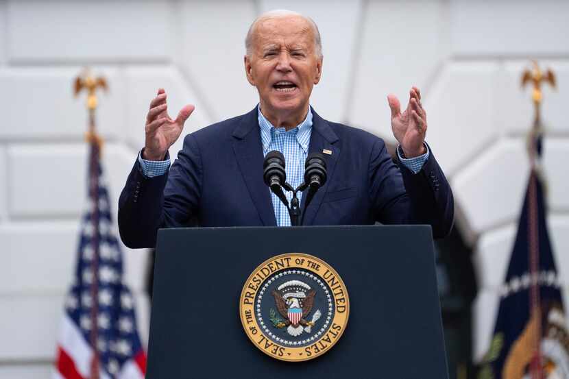 President Joe Biden speaks during a barbecue with active-duty military service members and...